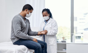 Doctor examining a male patient